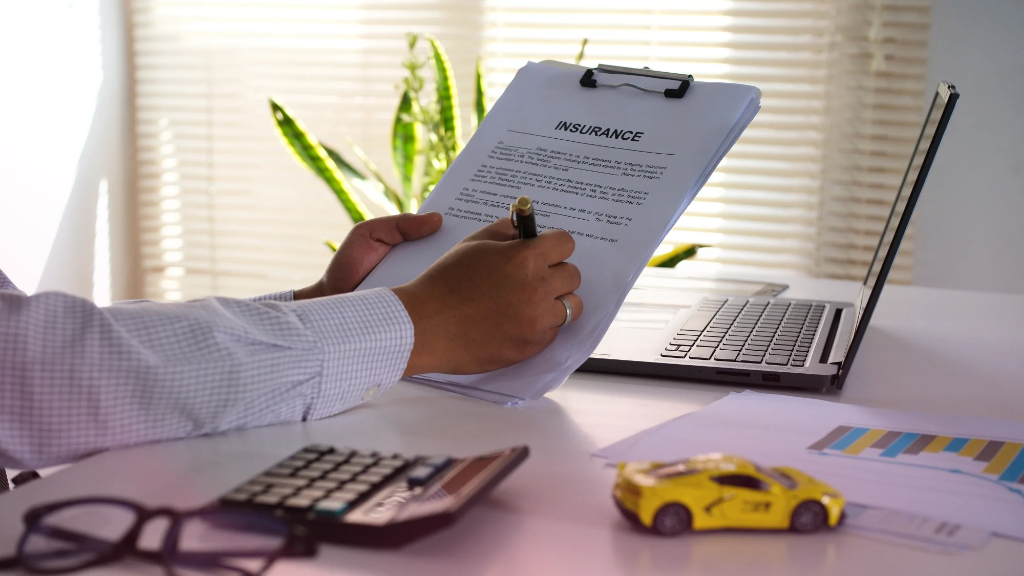 A person happily driving their insured vehicle on the road